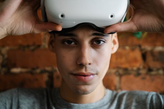 Close-up of a man wearing a VR headset indoors with a brick wall background.